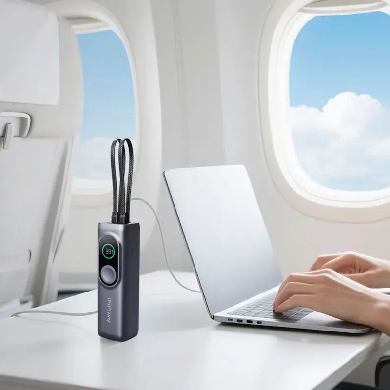 Inside an airplane cabin, an iFORWAY 25000mAh 170W power bank is charging a laptop on a tray table. This highlights its airline-approved capacity, making it an essential travel accessory for staying productive during long-haul business flights.