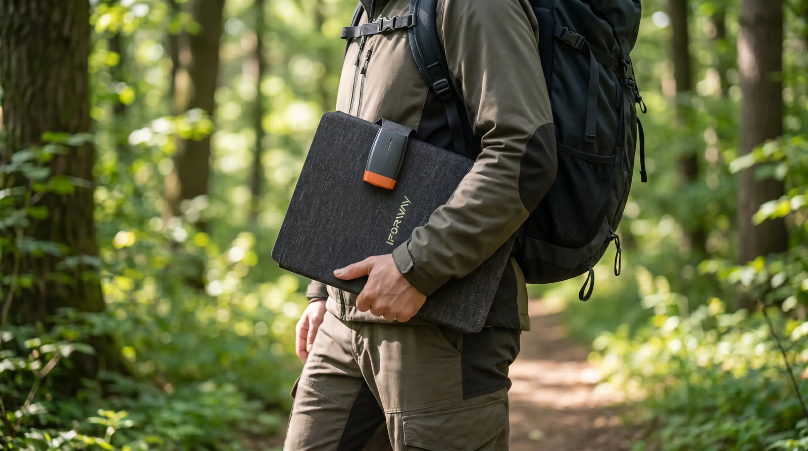 An ultra-realistic outdoor lifestyle photograph showing a hiker walking down a sunlit forest trail, casually carrying the folded iFORWAY 36W Backpacking Solar Charger in one hand. This perfectly highlights the charger's lightweight, compact, and highly portable design, proving it is easy to carry for any adventure. The sleek folded form features a durable textured exterior, demonstrating how effortlessly this off-grid power solution can be transported alongside your backpack