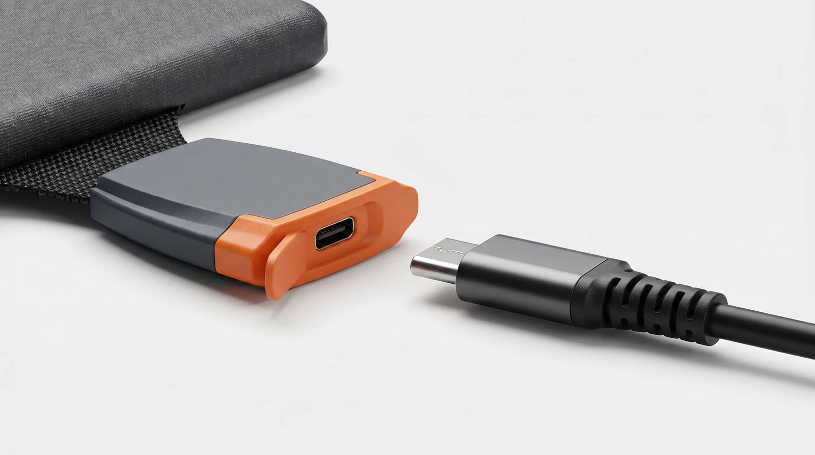 A macro product shot showing the fast USB-C charging port on the iFORWAY 36W Backpacking Solar Charger. The port is equipped with a protective orange rubber cover, demonstrating the 'Built Tough' waterproof, heat-resistant, and corrosion-proof design. A standard USB-C cable is shown ready to plug into the module, highlighting the easy-to-use fast charging capabilities and safe, reliable all-weather performance of this highly portable outdoor power solution