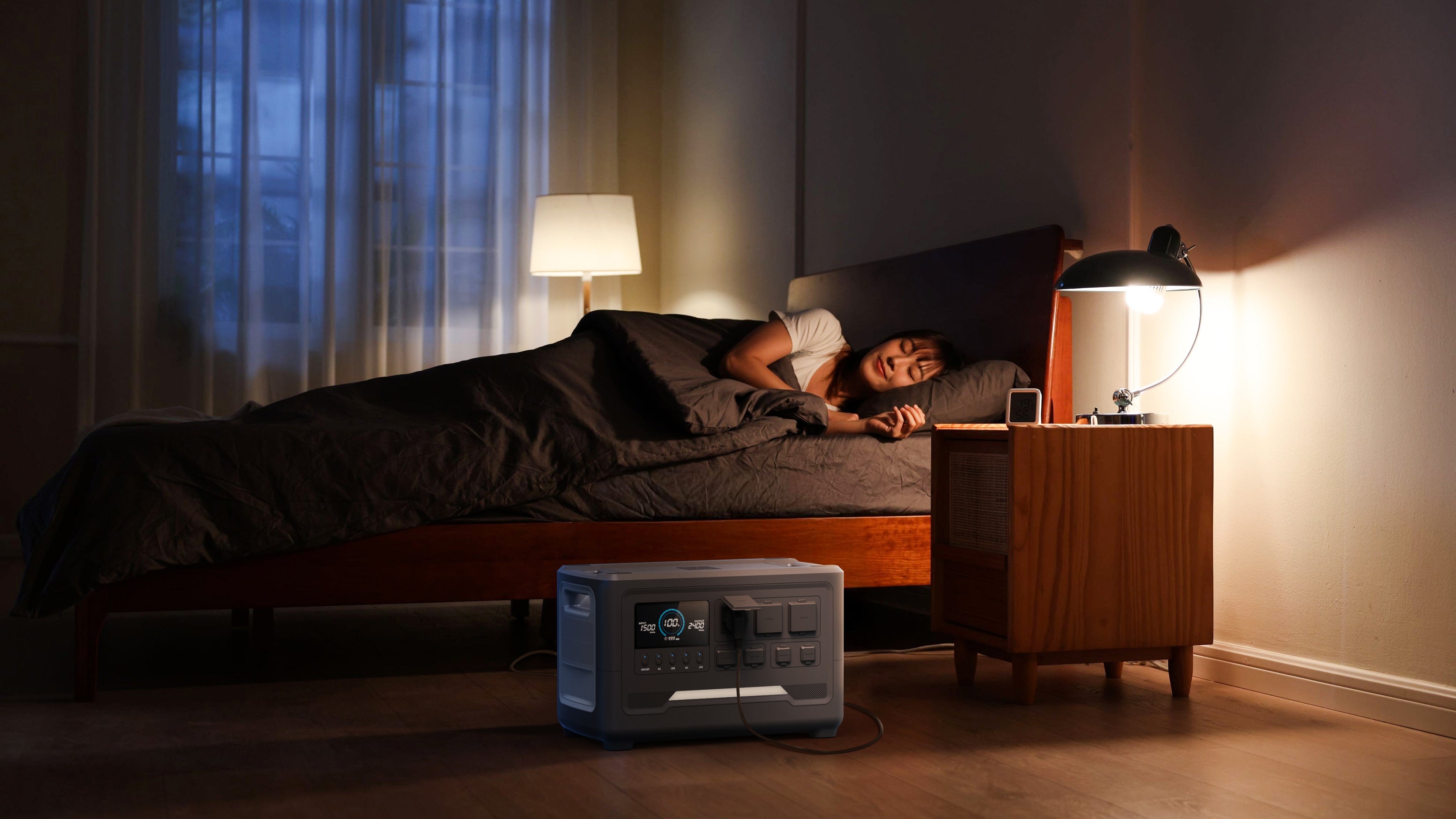 During a night-time power outage, the iFORWAY portable power station provides silent backup power for a bedside lamp, ensuring a peaceful sleep. This highlights its role as a reliable home emergency power source (UPS/EPS) with a quiet operation design, perfect for powering essential bedroom electronics and CPAP machines.